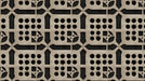 Abstract beige breeze block pattern with charcoal circular voids and architectural grid lines