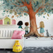 A cozy nursery featuring the tree mural behind a wooden crib with neutral bedding.