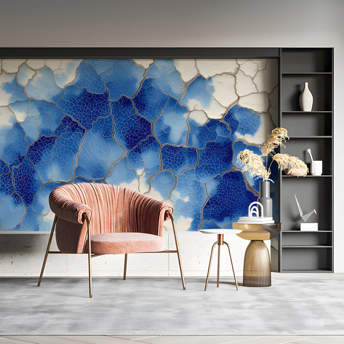 A bright entryway featuring a statement blue crackle mural on the main wall behind a charcoal sofa.