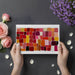 Modern home office with a vibrant painterly mosaic feature wall in warm red and orange tones