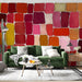 Living room interior featuring an abstract mosaic wallpaper in warm sunset colors on the main wall