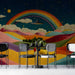 A cozy cafe featuring a vibrant mural wall with rolling hills and a starlit night sky.