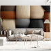 A cozy living room reading nook showcasing the textured block wall mural in a warm, neutral color palette.