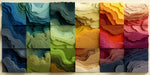 Abstract wallpaper featuring a grid of layered, textured topographic shapes in blue, green, yellow, orange, and berry tones.