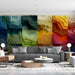 A contemporary living room with the abstract multi-colored mural, paired with minimalist furniture and warm lighting.