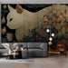 Dark botanical cat wallpaper installed in a cozy home library with a reading chair.
