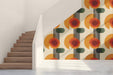 Stylish home office featuring retro circles mural wallpaper and a minimalist wooden desk