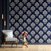 Luxury entryway interior featuring elegant navy floral damask wallpaper behind headboard.