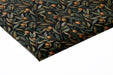 Dark botanical fruit wallpaper featured in an elegant dining room with brass lighting.