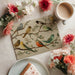 Botanical bird wall mural featured in a bright dining room with a wooden table and minimalist chairs.