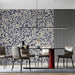 An elegant dining room with a dark floral damask feature wall and minimalist modern furniture.