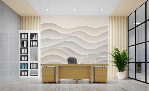 A serene office with a soft beige wave mural behind a wooden headboard.