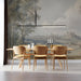 A dining room interior with a serene European countryside mural creating a focal point behind a wooden table.