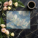 Swirling cloud wall mural featured in a calm nursery with minimalist wooden furniture.