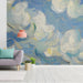 Impressionist sky mural installed in a light-filled entryway with linen bedding.