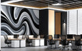 Monochrome swirl wallpaper behind a modern office with minimalist decor.