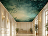 A hall with a forest canopy wall mural behind a tufted headboard.
