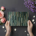 Minimalist dining room space with vertical sage green wood slat mural