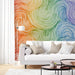 Modern living room featuring a vibrant rainbow swirl mural as a statement focal wall