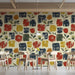 A bright dining room featuring the abstract floral mural as an accent wall with wooden furniture.