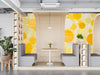 Bright yellow circular patterned wallpaper in a sunlit modern restaurant