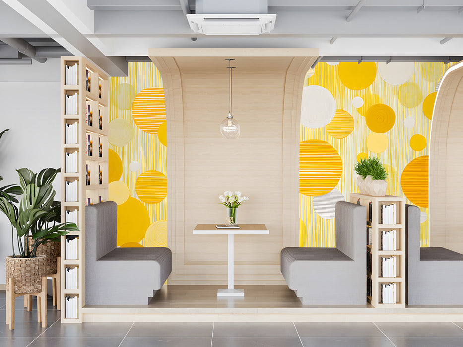 Bright yellow circular patterned wallpaper in a sunlit modern restaurant