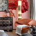 The rose branch wallpaper installed as a soft feature wall behind a white vanity in a dressing room.