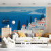 Mediterranean wall mural installed in a bright modern living room with wooden furniture