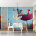 A imaginative dining room decorated with the whimsical garden mural and a velvet armchair.