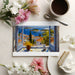 Scenic seaside window view wallpaper in a home office space with natural light