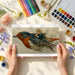 Dreamy bird illustration wall mural in a childs bedroom with soft lighting
