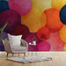 A bright, colorful abstract mural installed as an accent wall in a minimalist study.
