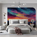 Artistic bedroom showcasing a textured mountain sunset mural as a creative backdrop.