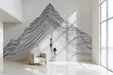 A clean, modern home office wall featuring a black and white mountain line art mural.