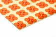 A playful kid's playroom decorated with retro orange flower pattern mural.