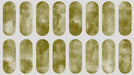 Olive green oval shapes in a repeating grid pattern with a painterly texture on a light gray background