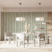A cozy home office with sage green striped wallpaper on a feature wall behind a wooden desk.