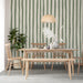 A serene dining room with hand-drawn stripe wallpaper creating a calming, organic backdrop.