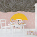Whimsical weather-themed wallpaper in a bright and playful kids playroom