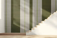 A bright, modern entryway featuring vertical olive and cream striped wallpaper.