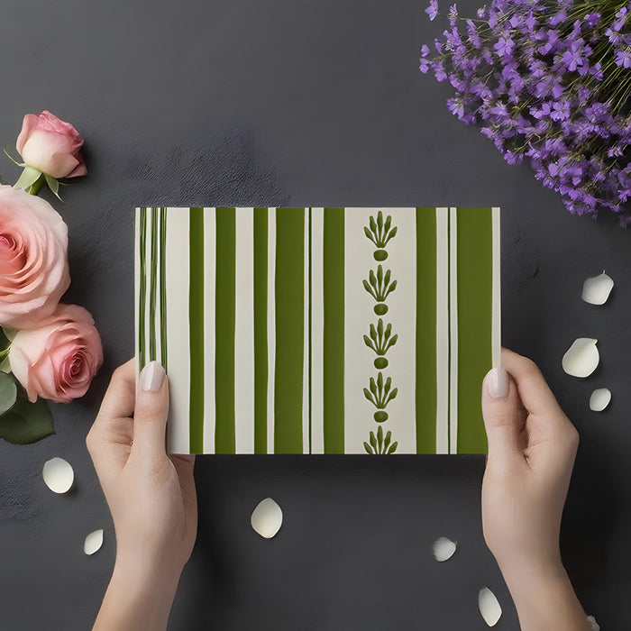 Minimalist home entryway decorated with sage and cream vertical stripe mural wallpaper