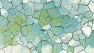 Abstract mosaic wallpaper with smooth stone shapes in mint, sage green, and white, separated by glass-like blue fissures.