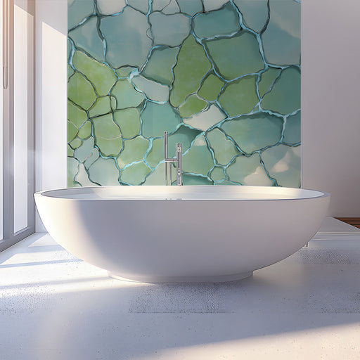 Glacial stone mosaic wallpaper installed in a calming bathroom with light wood furniture.