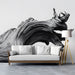 Modern study with a large black and white driftwood mural behind a sofa