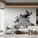 Serene living room with an artistic black and white nature mural above a bed with crisp white linens.