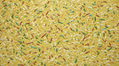 Ochre yellow mural wallpaper featuring scattered white, green, and red paint-like sprinkles