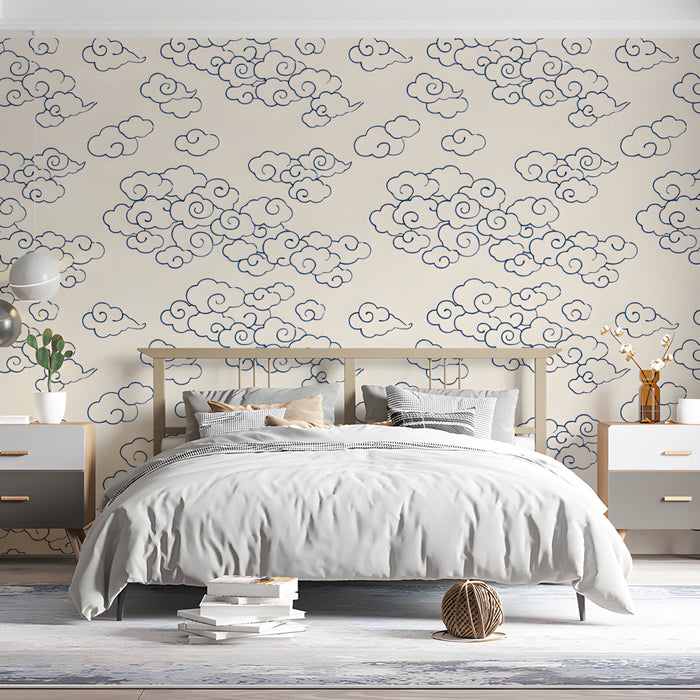 Bedroom featuring navy and cream cloud wallpaper behind a minimalist wooden sofa