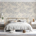 Bedroom featuring navy and cream cloud wallpaper behind a minimalist wooden sofa