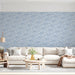 Minimalist bedroom wall with blue cloud pattern behind a wooden bed frame
