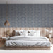 Geometric cloud pattern wallpaper behind a bedroom